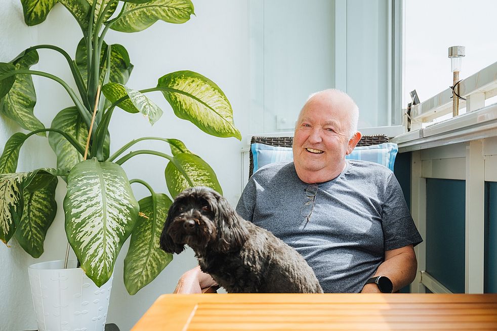 Wolfgang Zetzsche mit Mischling Benni auf dem Balkon.